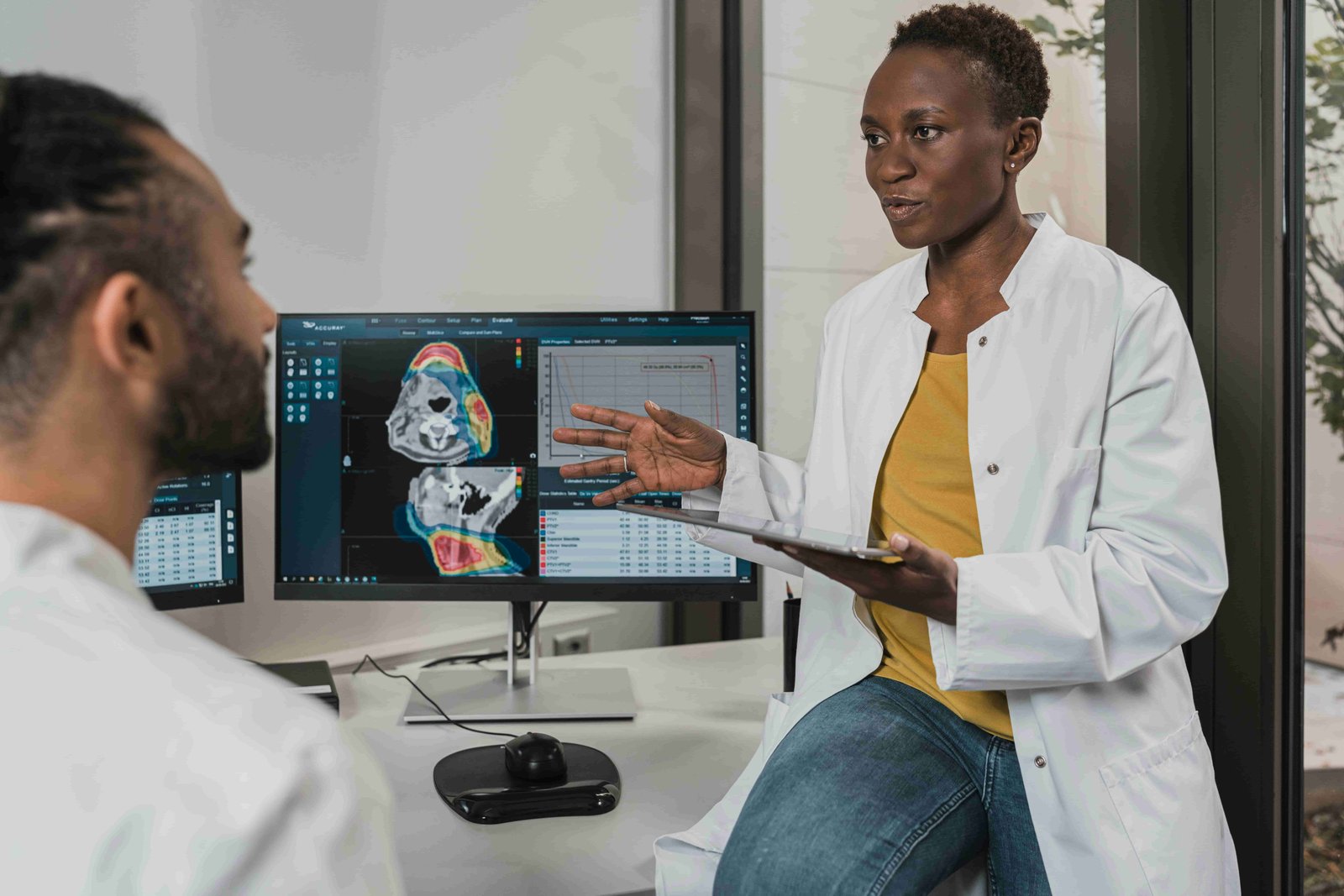 Doctor showing a medical scan on a computer screen